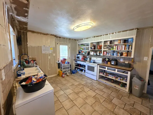 a room with furniture a couch and a bookshelf