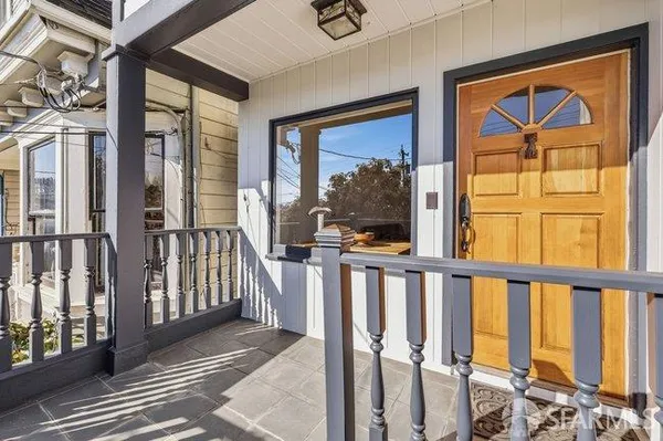 a view of a front door and wooden floor