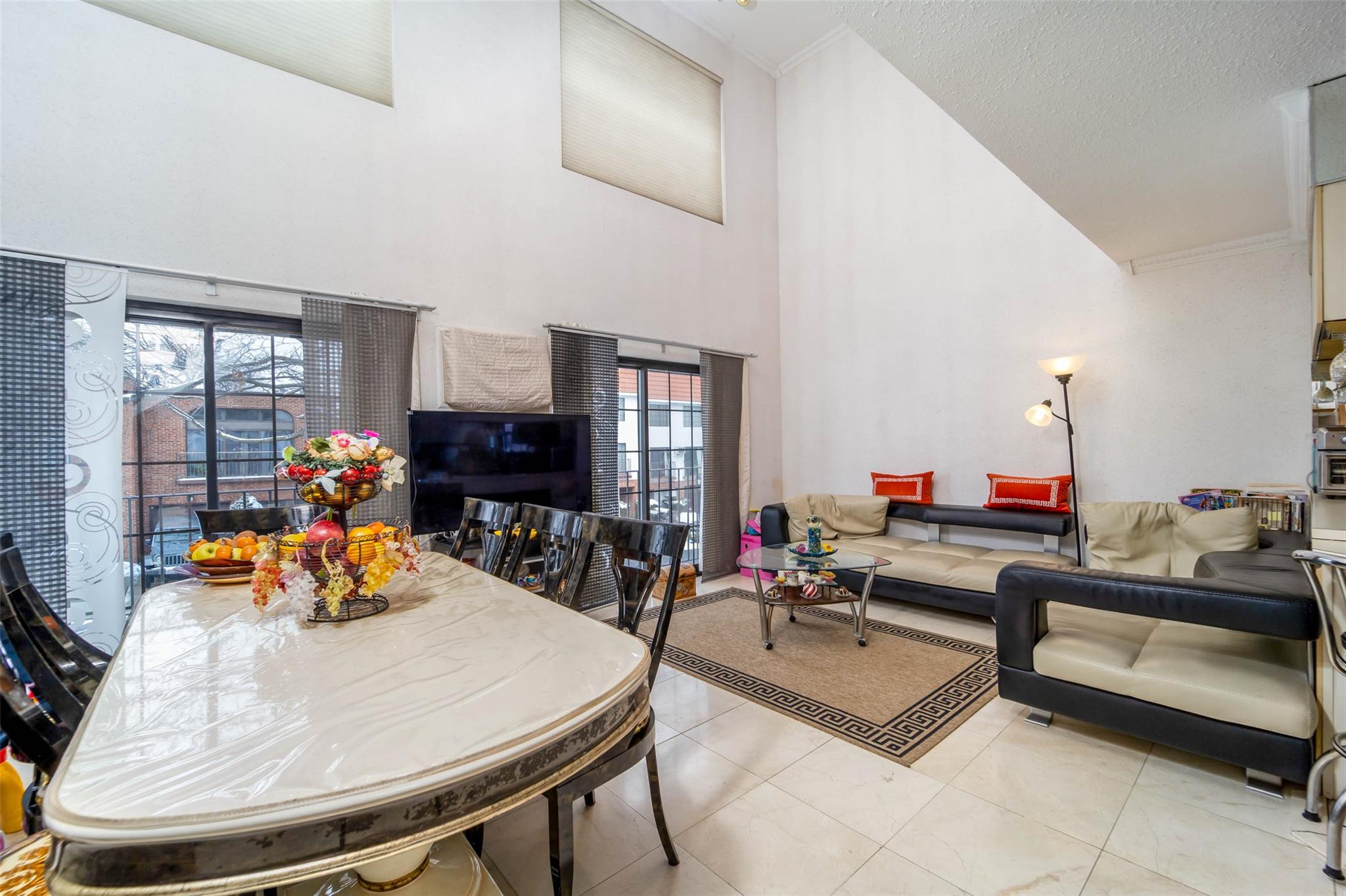 509 Julius Road Queens, NY 11356 - Photo 10 of 26 Dining area featuring a towering ceiling and tile patterned floors