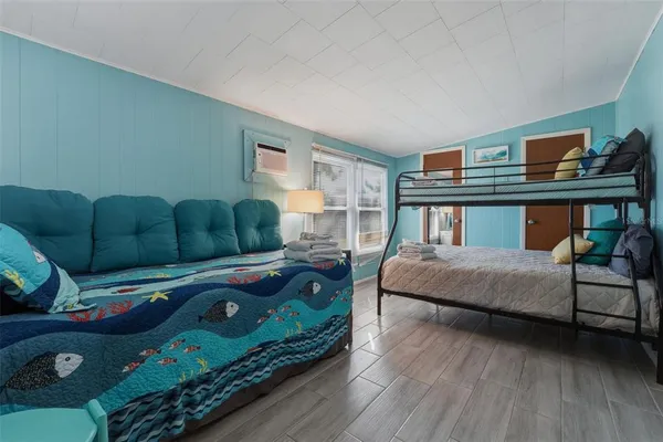 a bedroom with furniture and a window