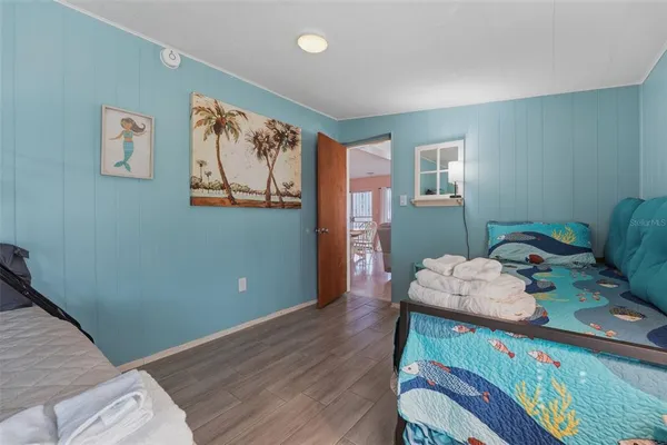 a bedroom with furniture and a wooden floor