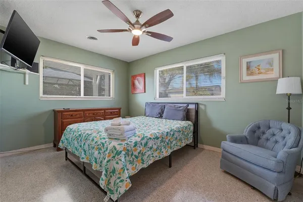 a bedroom with a bed couch and a window