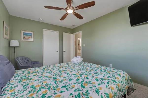 a bedroom with a bed and a flat screen tv