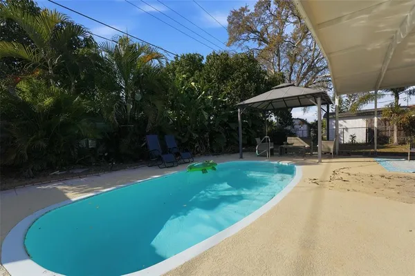 a view of a backyard with a garden and trees