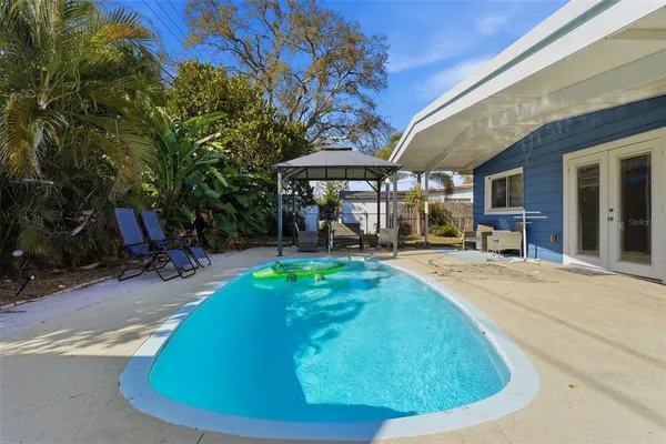 a view of a swimming pool with sitting area
