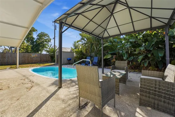 a view of a swimming pool with a patio