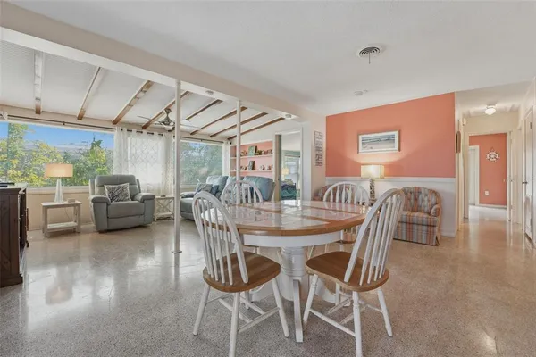 a dining room with furniture and wooden floor