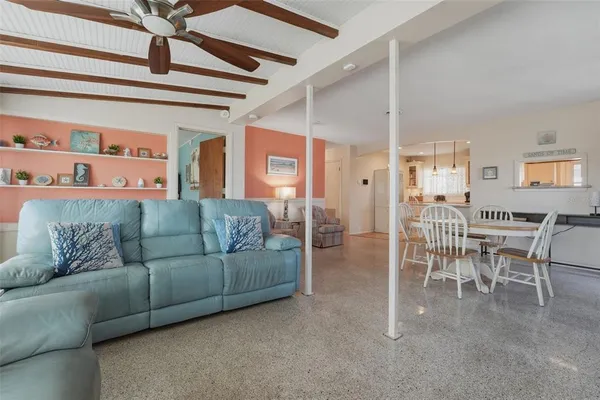 a living room with lots of furniture and a large window