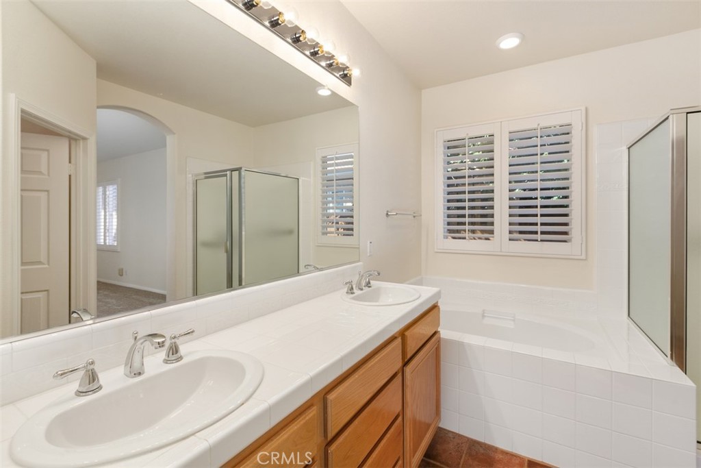 31292 Firestone Street Temecula, CA 92591 - Photo 12 of 19 a bathroom with a bathtub sink and mirror