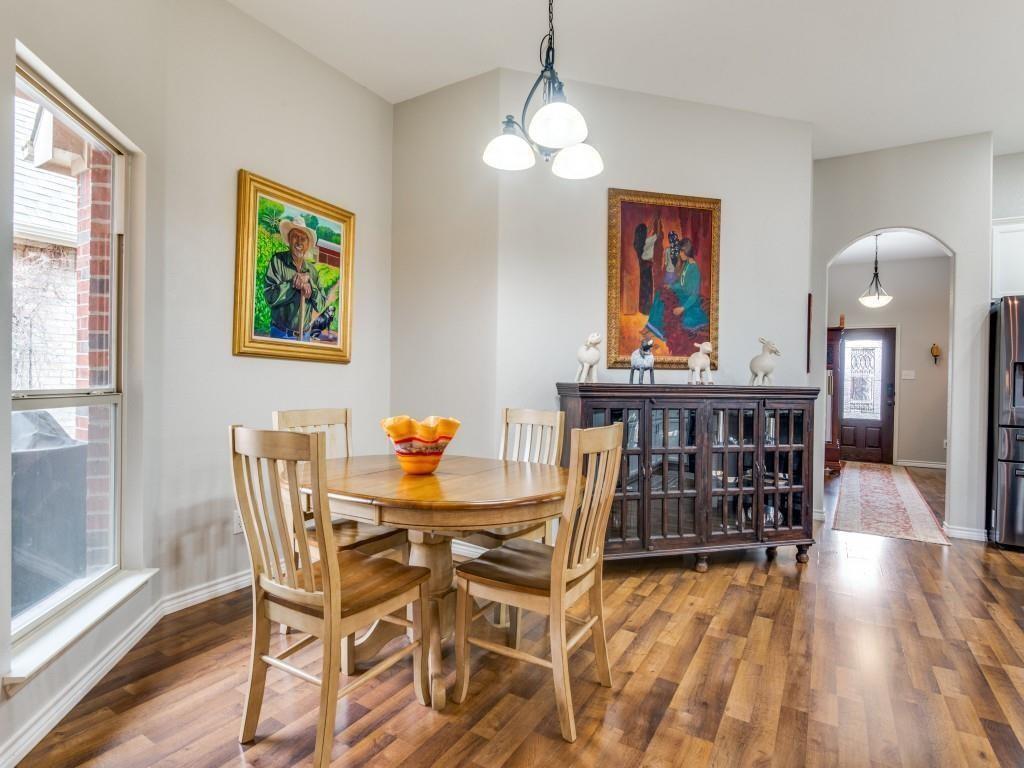 9962 Bell Rock Road Frisco, TX 75035 - Photo 5 of 28 a view of a dining room with furniture wooden floor and chandelier