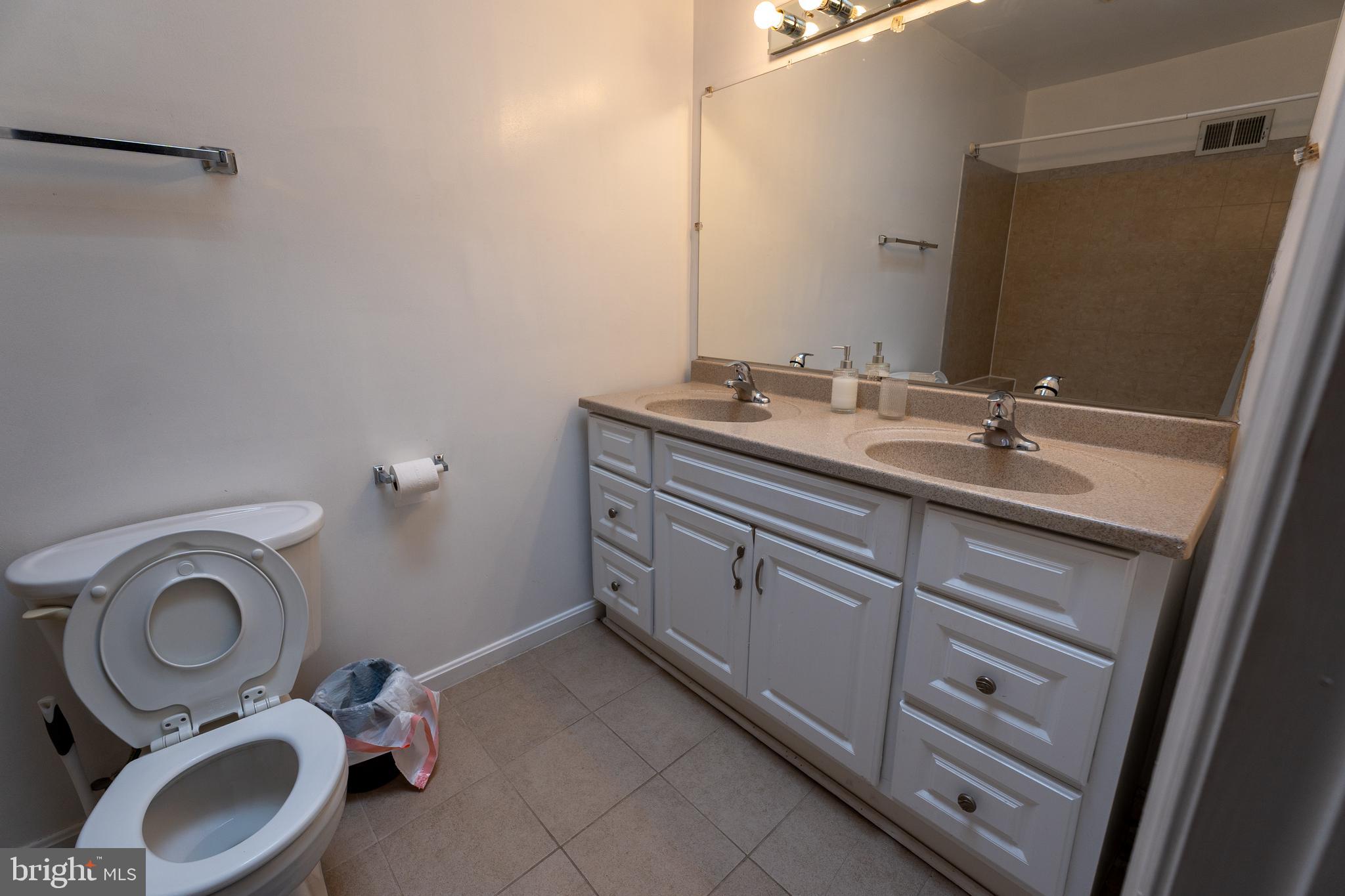 4705 8th Street Northwest Washington, DC 20011 - Photo 13 of 30 a bathroom with a granite countertop toilet sink and mirror