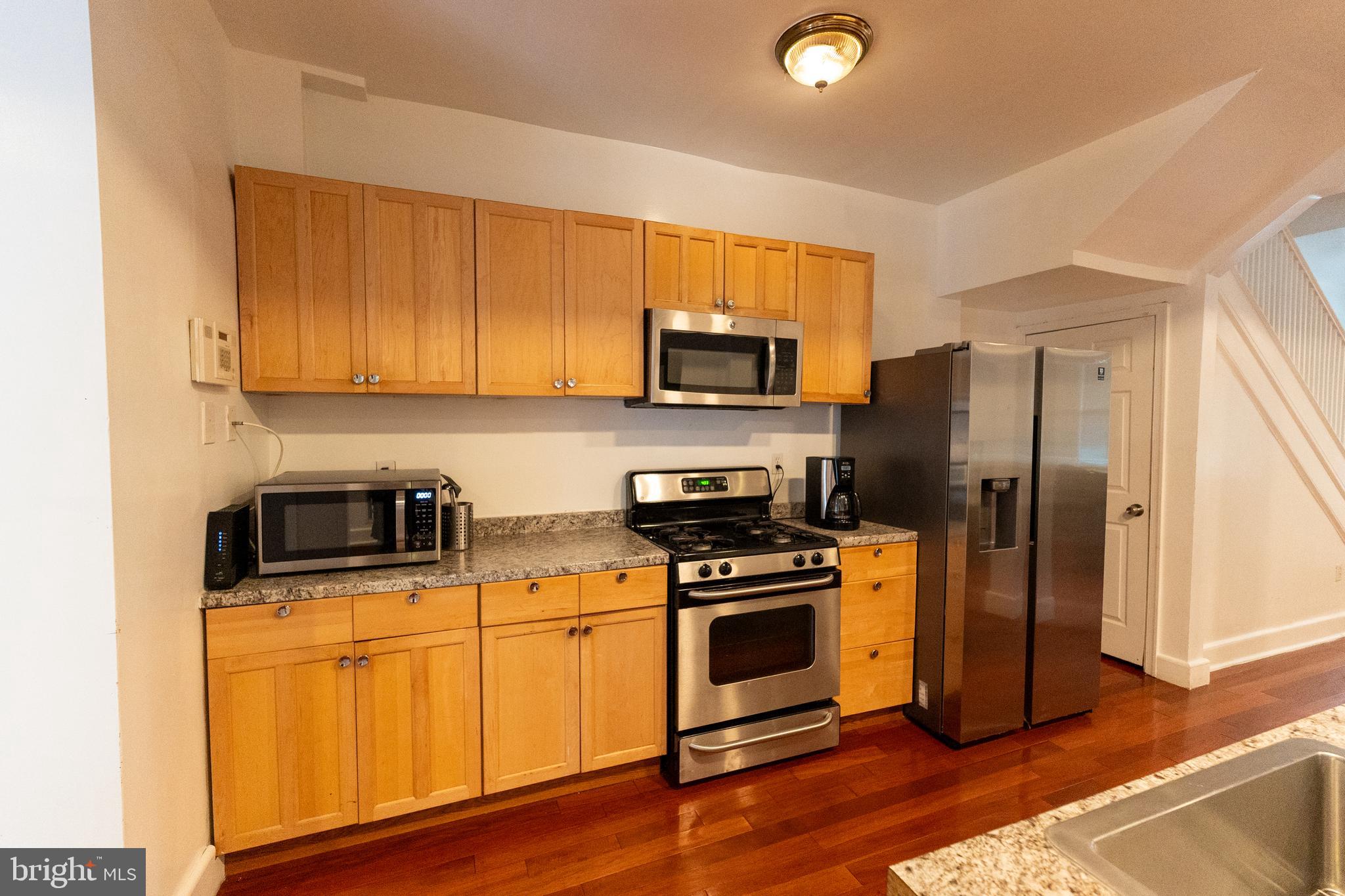 4705 8th Street Northwest Washington, DC 20011 - Photo 19 of 30 a kitchen with wooden cabinets and stainless steel appliances