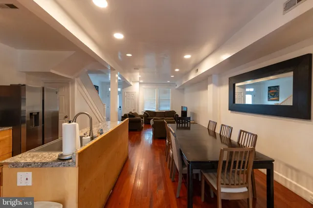 a view of a dining room with furniture and a potted plant