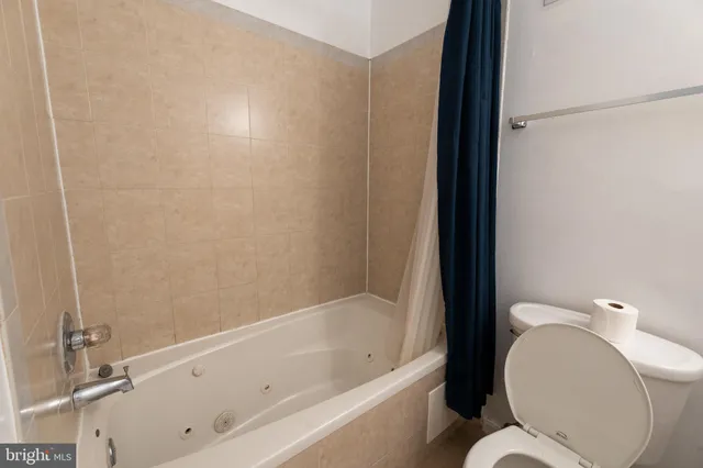 a bathroom with a bathtub and a toilet