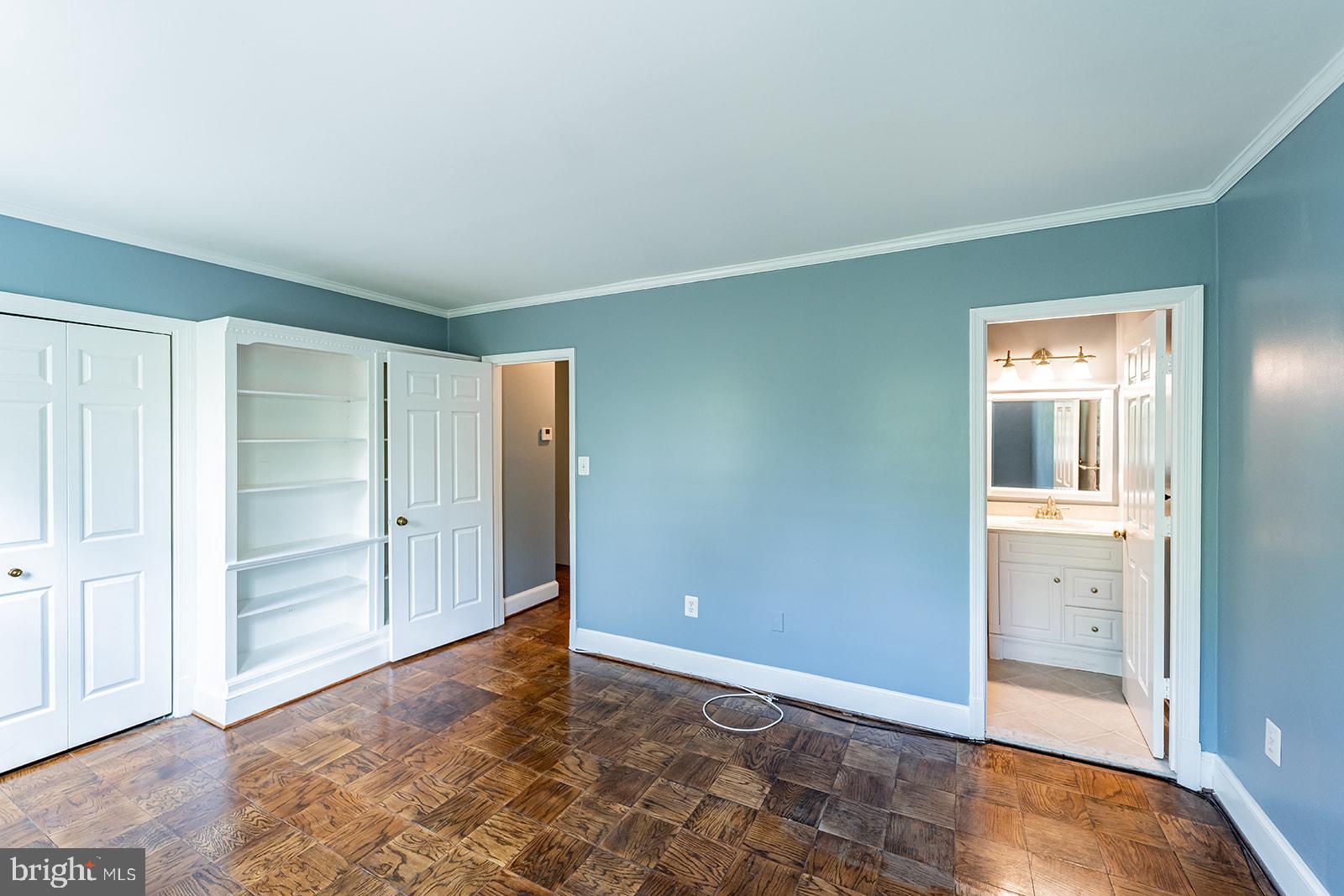 3237 Sutton Place Northwest, Unit A Washington, DC 20016 - Photo 34 of 54 2nd Bedroom facing bathroom and built-in shelving.