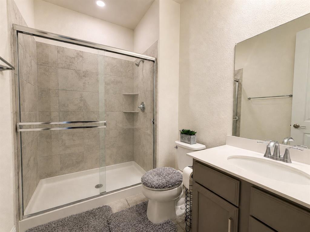 3598 Furrow Road Frisco, TX 75035 - Photo 4 of 14 a bathroom with a granite countertop sink toilet and shower