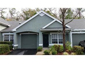 3648 Kings Road, Unit 103 Palm Harbor, FL 34685 - Photo 1 of 1 a black and white building with a yard