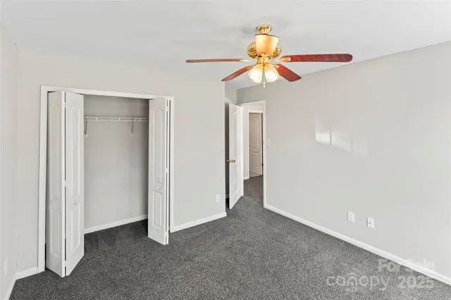 a view of an empty room with a fan