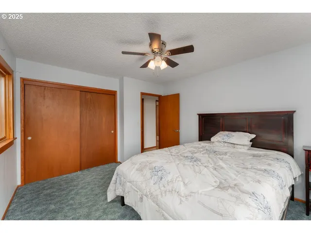 a bedroom with a bed and a night stand