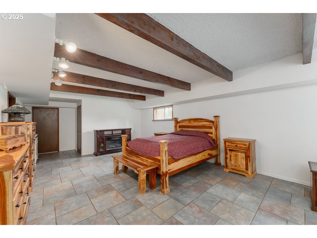 402 Northside Road Sutherlin, OR 97479 - Photo 19 of 46 a bedroom with furniture and a fireplace