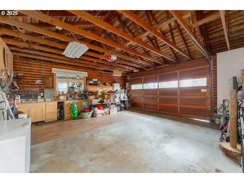 402 Northside Road Sutherlin, OR 97479 - Photo 25 of 46 a view of a garage with a bike and wooden roof