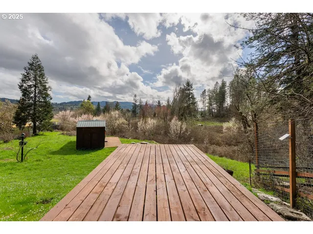 a view of a backyard with wooden fence