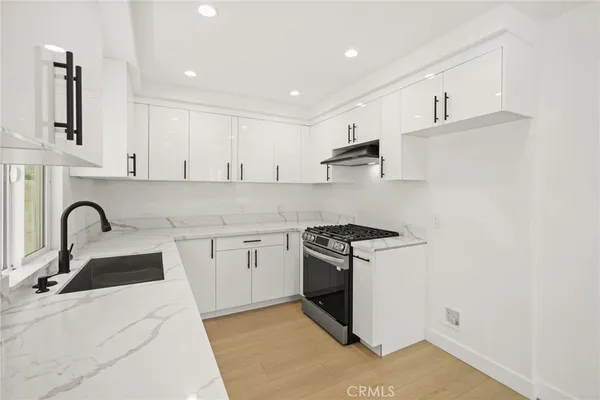 a kitchen with stainless steel appliances granite countertop a sink and cabinets