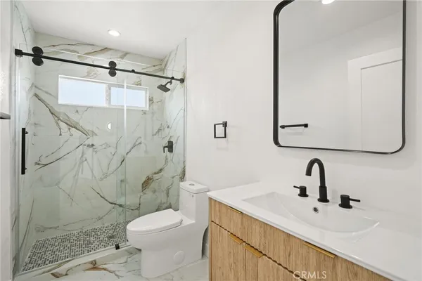 a bathroom with a sink toilet and shower