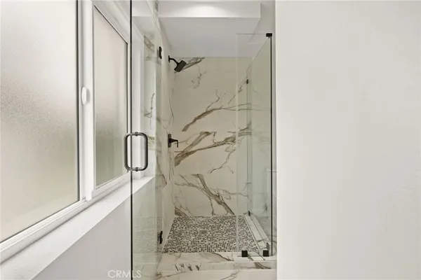 a bathroom with a glass shower door