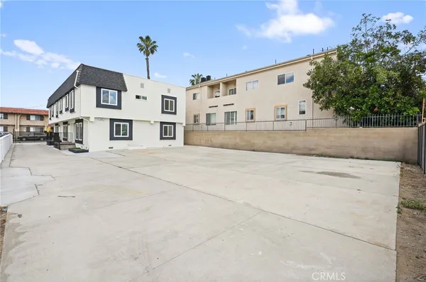 an aerial view of multi story residential apartment building with yard