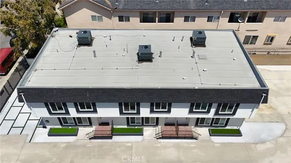 an aerial view of a house with a yard