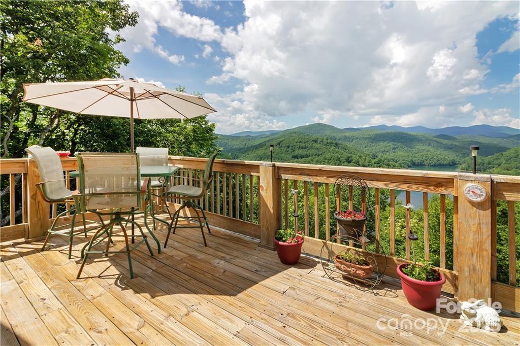 612 Old Home Place Road Tuckasegee, NC 28783 - Photo 11 of 42 a view of a balcony with chairs and wooden floor