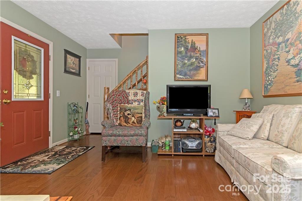 612 Old Home Place Road Tuckasegee, NC 28783 - Photo 12 of 42 a living room with furniture and a flat screen tv