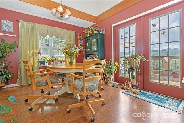 a view of a dining room with furniture wooden floor and a chandelier