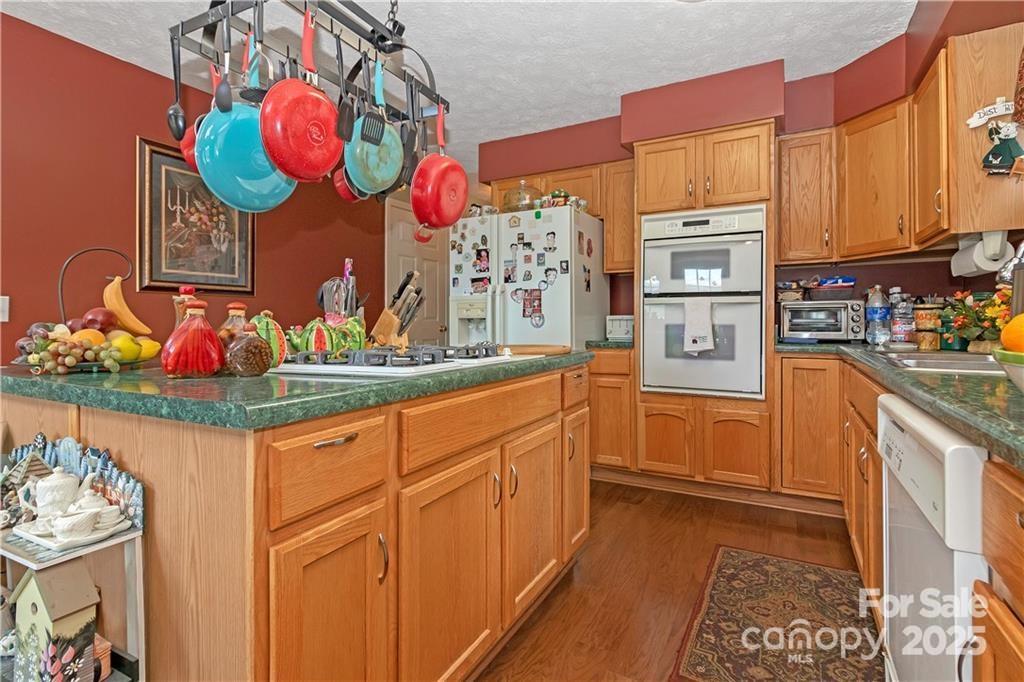 612 Old Home Place Road Tuckasegee, NC 28783 - Photo 18 of 42 a kitchen with stainless steel appliances granite countertop a sink and cabinets