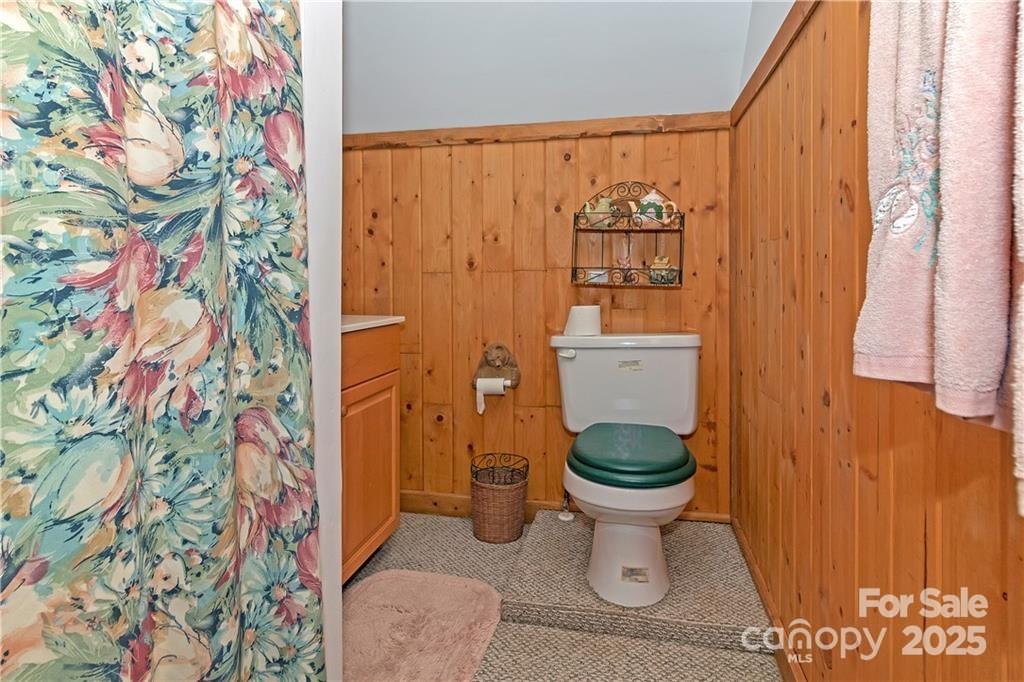612 Old Home Place Road Tuckasegee, NC 28783 - Photo 24 of 42 a bathroom with a toilet and a shower curtain