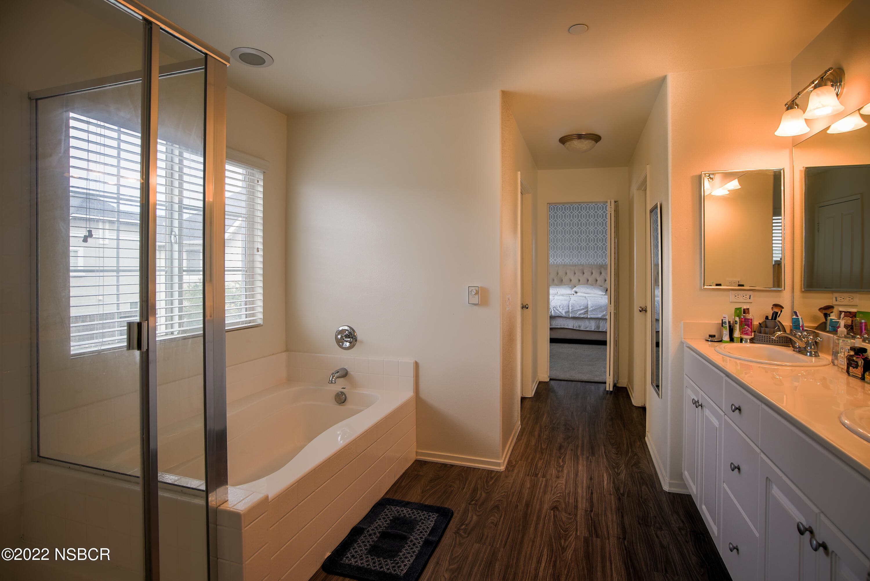 1307 Crown Circle Lompoc, CA 93436 - Photo 20 of 34 a bathroom with a bathtub a sink and a large mirror
