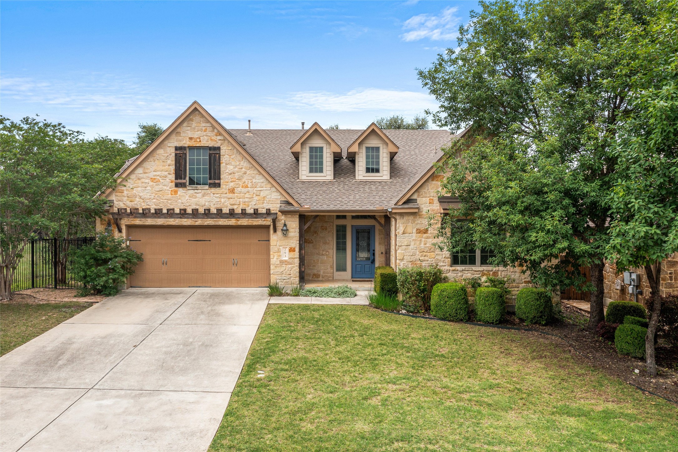 Stone facade residence with an attached two-car garage