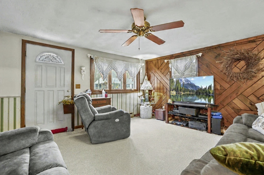 38 Candice Street Clinton, MA 01510 - Photo 7 of 13 a living room with furniture ceiling fan and a window