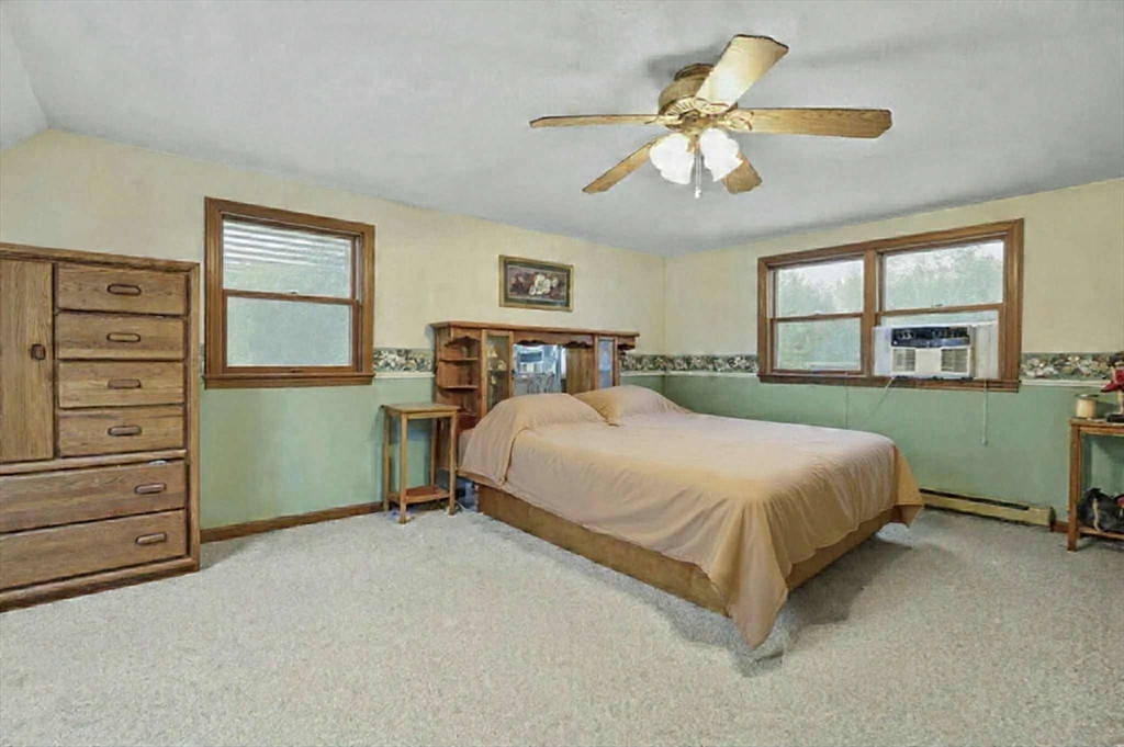 38 Candice Street Clinton, MA 01510 - Photo 9 of 13 a bedroom with a bed and a chandelier