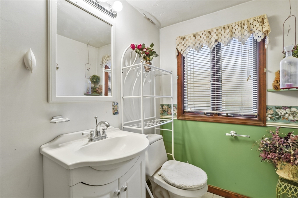 38 Candice Street Clinton, MA 01510 - Photo 10 of 13 a bathroom with a sink mirror and toilet