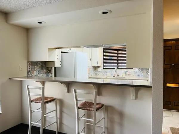 a kitchen with stainless steel appliances a sink and cabinets