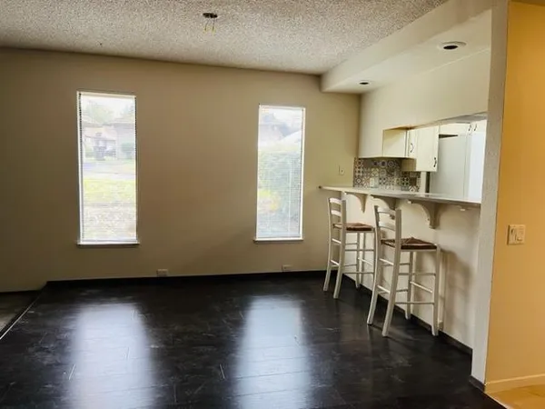 a view of kitchen and hall with wooden floor