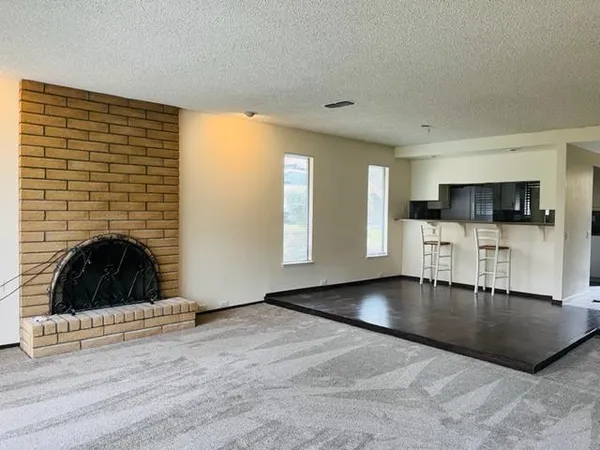 a view of a kitchen with a sink and a fireplace