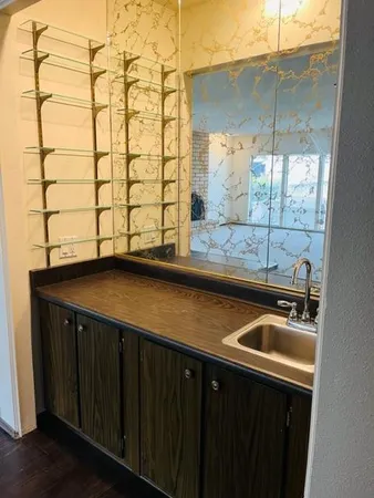 a kitchen with a sink and cabinets