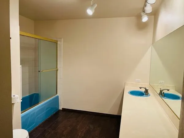 a bathroom with a tub and shower