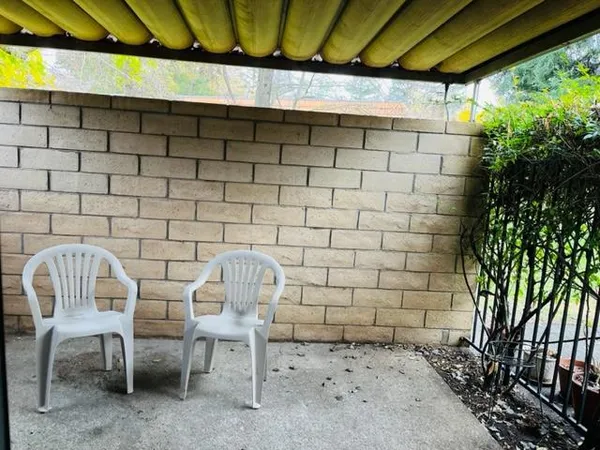 a view of a chairs and table in patio