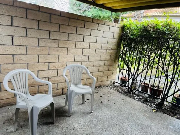 a view of a chairs and table in backyard
