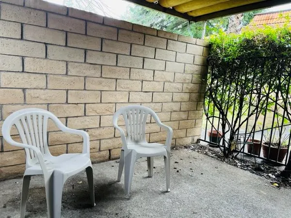 a view of a chairs and table in a patio