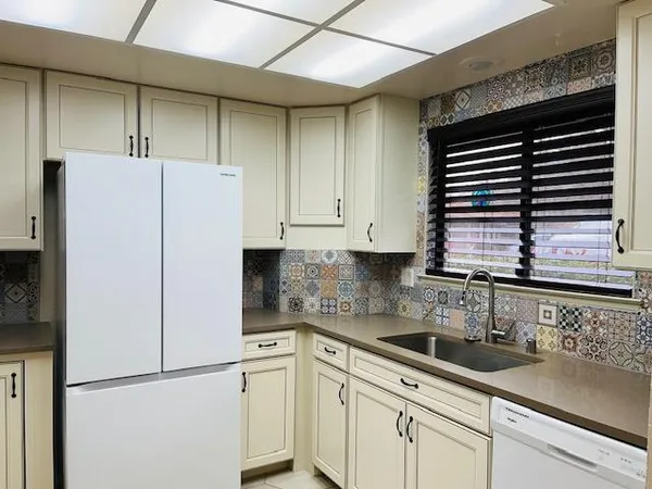 a kitchen with stainless steel appliances white cabinets and a sink